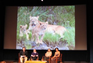 On stage are the “Lion Ladies” with moderator Luke Dollar, a wildlife conservationist in Madagascar: Amy Dickman, Laly Lichtenfeld, Paula Kahumu.